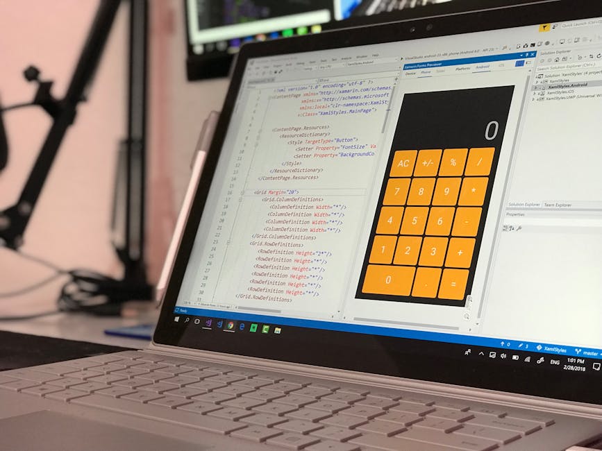 A close-up view of a laptop screen displaying a coding interface with HTML and CSS code on the left side, and a large, orange calculator application with basic functions on the right side. The backgro